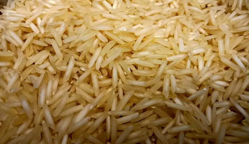 Long-grain white basmati rice on a wooden surface