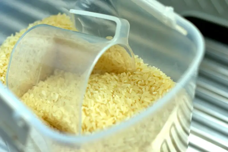 Scooping raw rice from an open sack