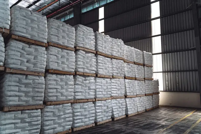 Warehouse stacked with rows of white rice bags